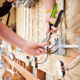 Student using pliers on wiring