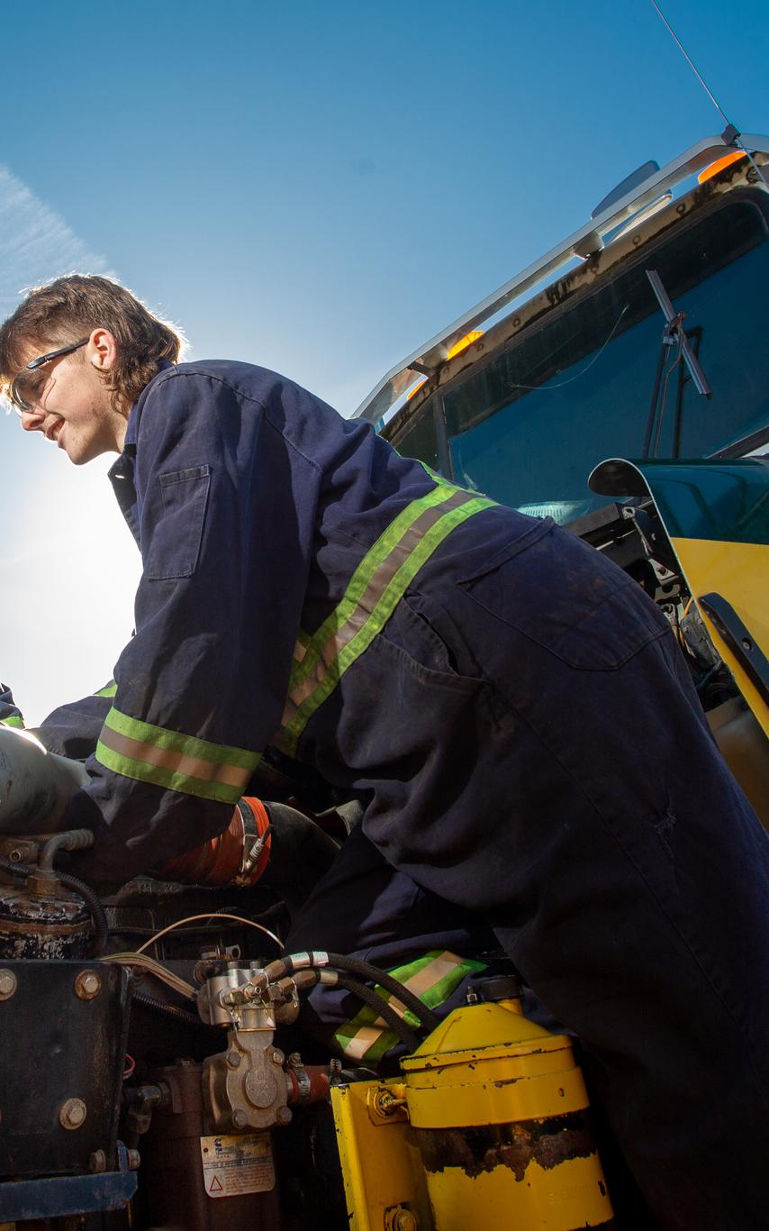Two VIU heavy mechanical trades students work on the engine of a truck